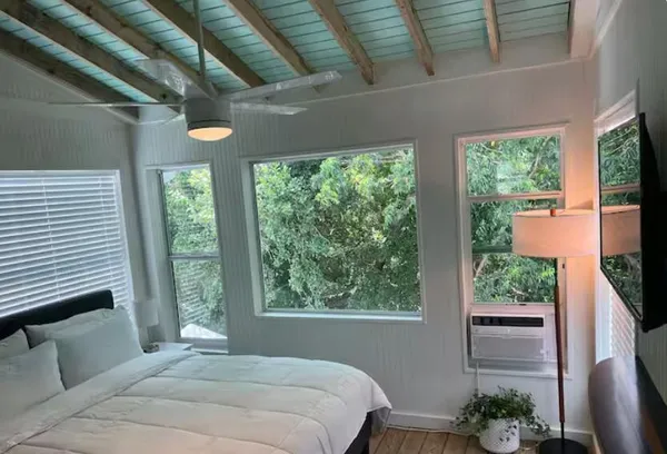 a bedroom with a bed and a window