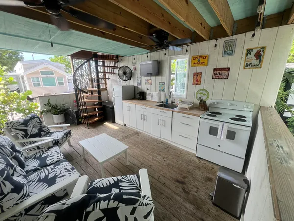 a kitchen with stainless steel appliances granite countertop a sink a stove top oven a counter space and cabinets