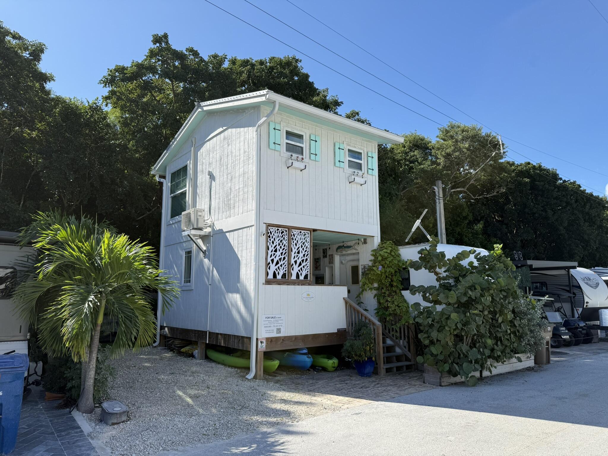 325 Calusa Street, Unit 121 Key Largo, FL 33037 - Photo 5 of 21 a view of a house with a yard and potted plants