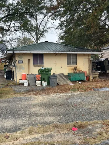 a front view of a house with cars parked