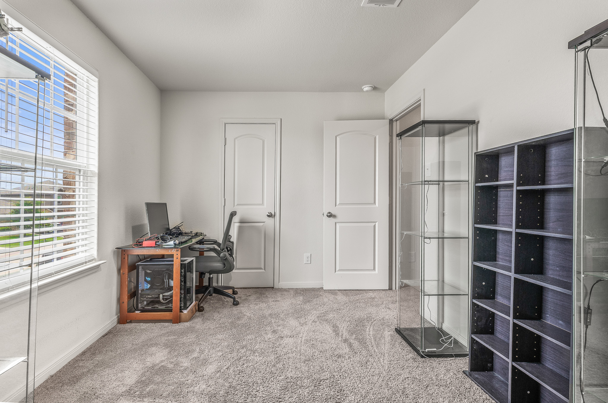 304 Hyacinth Way, Unit #7K Jarrell, TX 76537 - Photo 18 of 26 A quiet office space offers ample natural light and plush carpeting, ideal for focused work.
