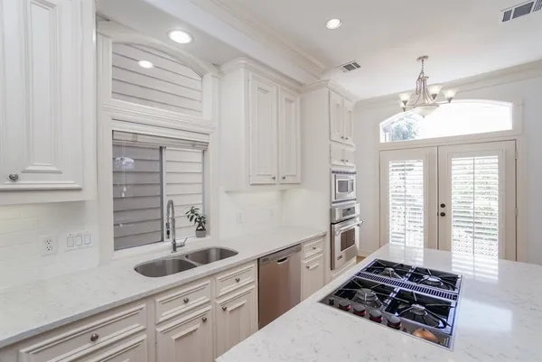 a bathroom with a granite countertop tub sink and mirror
