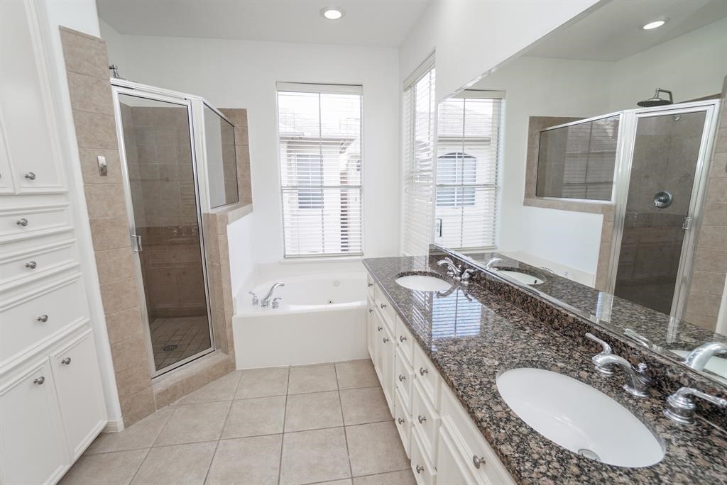 4406 Feagan Street, Unit A Houston, TX 77007 - Photo 20 of 29 a bathroom with a granite countertop tub sink and mirror