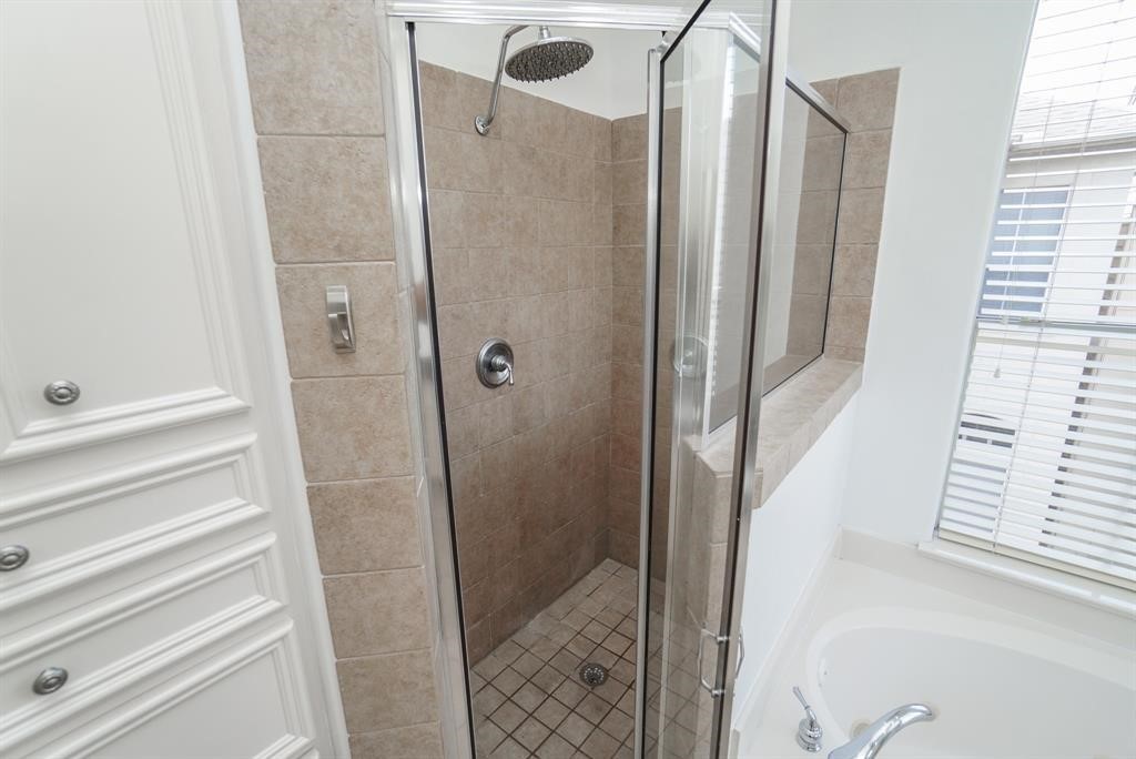 4406 Feagan Street, Unit A Houston, TX 77007 - Photo 22 of 29 a bathroom with a shower and a glass door