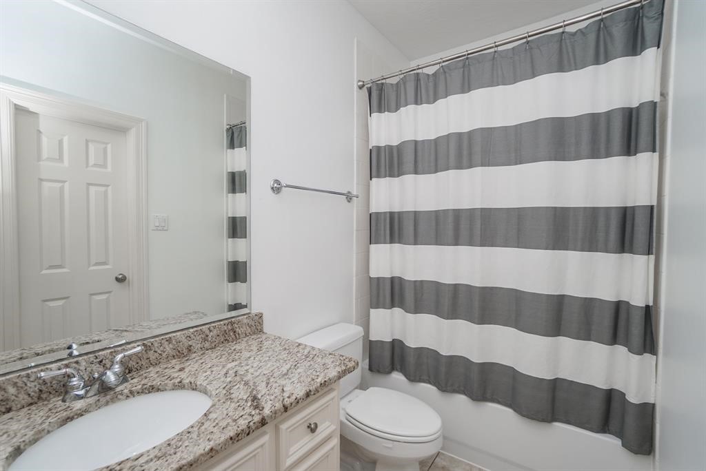 4406 Feagan Street, Unit A Houston, TX 77007 - Photo 25 of 29 a bathroom with a sink and a mirror