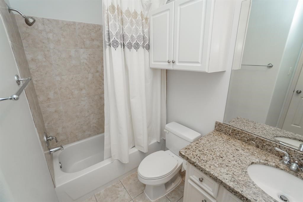 4406 Feagan Street, Unit A Houston, TX 77007 - Photo 29 of 29 a bathroom with a granite countertop sink toilet and shower