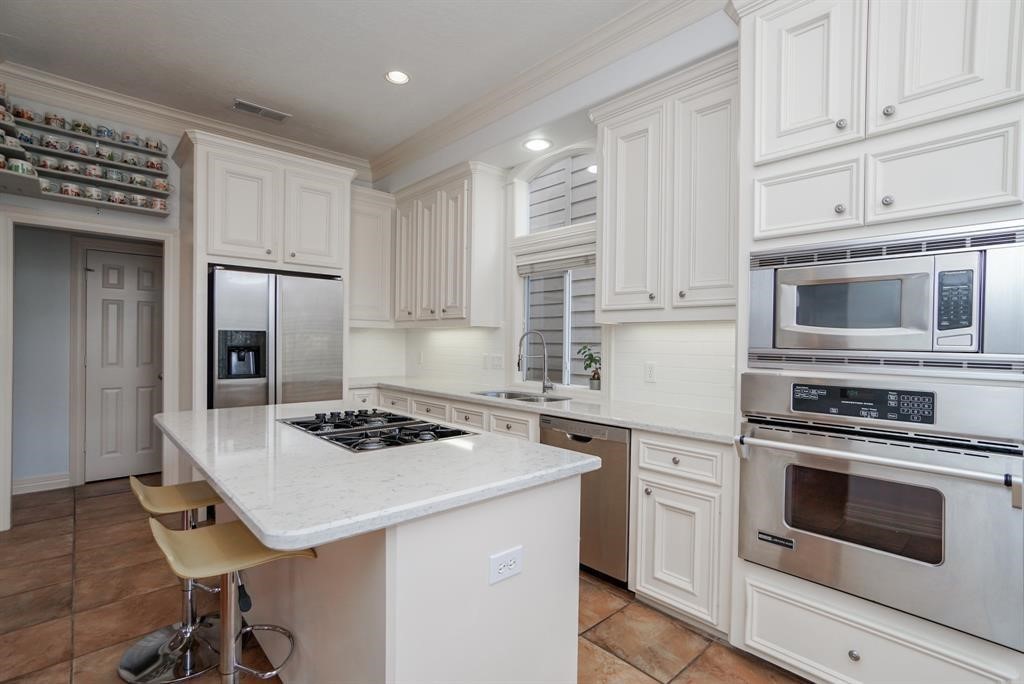 4406 Feagan Street, Unit A Houston, TX 77007 - Photo 10 of 29 a kitchen with cabinets appliances a sink and a counter top space