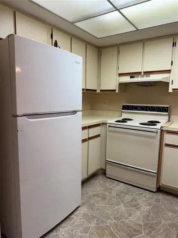 a white refrigerator freezer sitting in a kitchen