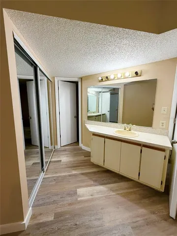 a spacious bathroom with a double vanity sink and a mirror