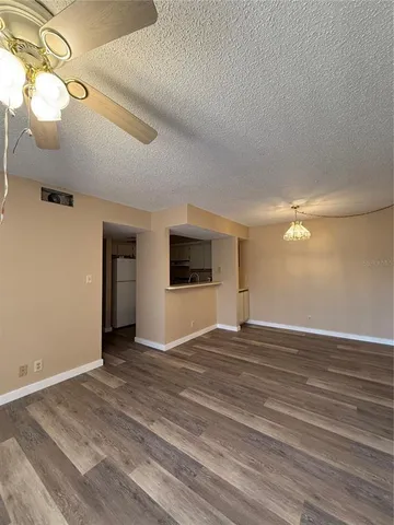 a view of an empty room and wooden floor