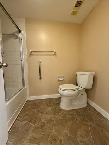 a bathroom with a toilet and a shower