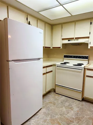 a white refrigerator freezer sitting in a kitchen