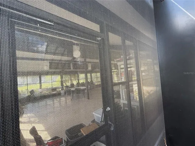 a room with wooden floor and floor to ceiling window