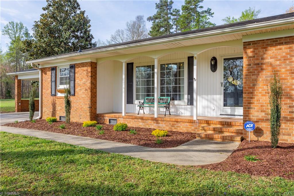 Accents include very fresh landscaping and a cozy porch with a partial view of the nearby lake!