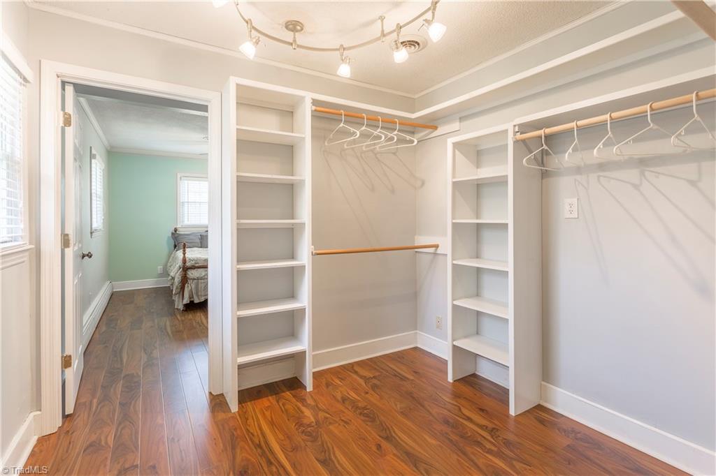 5104 Mockingbird Road Greensboro, NC 27406 - Photo 14 of 25 The Master Suite includes this large Walk In Closet with great shelving and storage, plus upscale lighting! Beautiful flooring and plenty of daylight too!