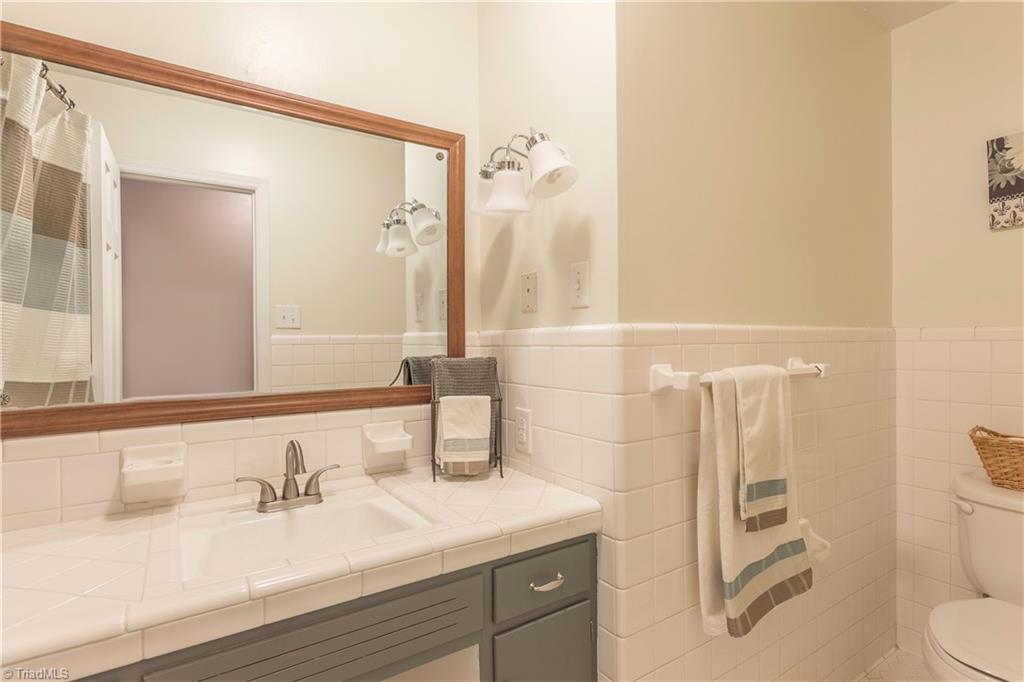 5104 Mockingbird Road Greensboro, NC 27406 - Photo 18 of 25 Classic ranch Hall Bath features Retro-style tiles combined with other modern features!