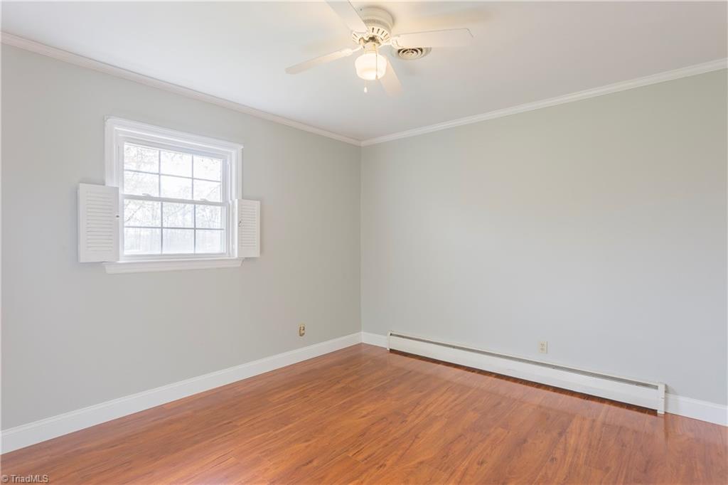 5104 Mockingbird Road Greensboro, NC 27406 - Photo 19 of 25 Even larger 3rd Bedroom features great floors, ample closet, and even cute half-shutters!