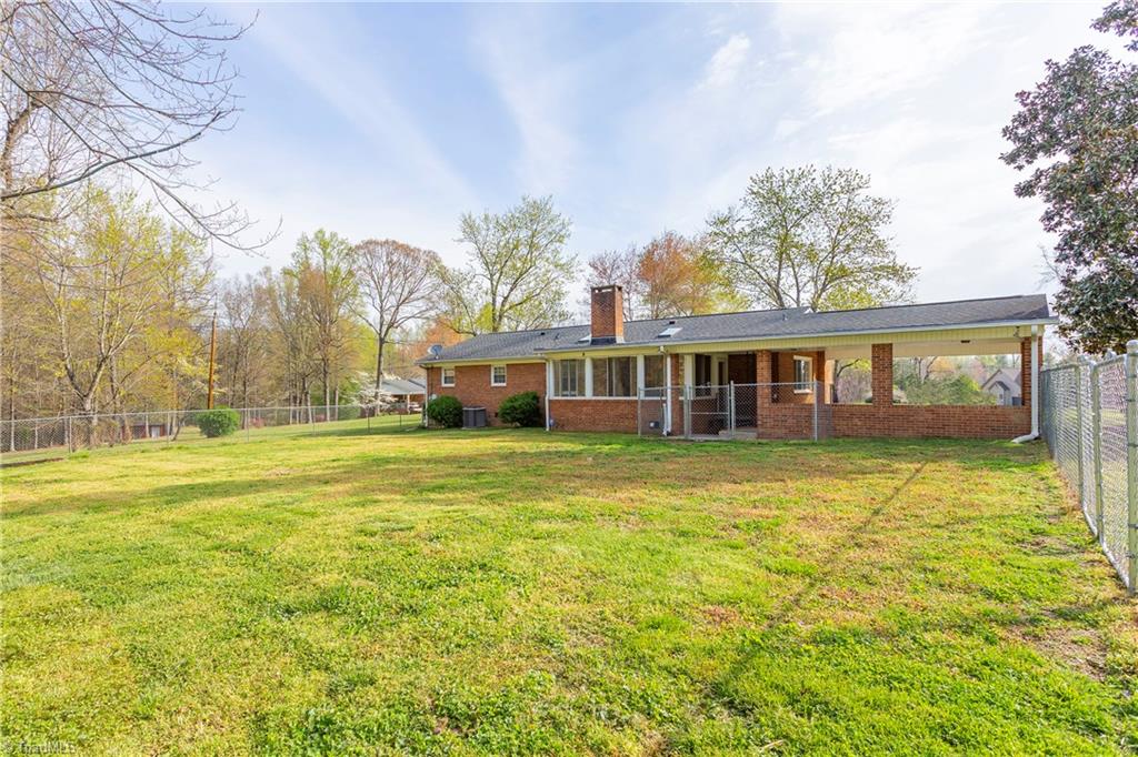 5104 Mockingbird Road Greensboro, NC 27406 - Photo 23 of 25 The back yard is partially fenced, perfect for pets and other uses!