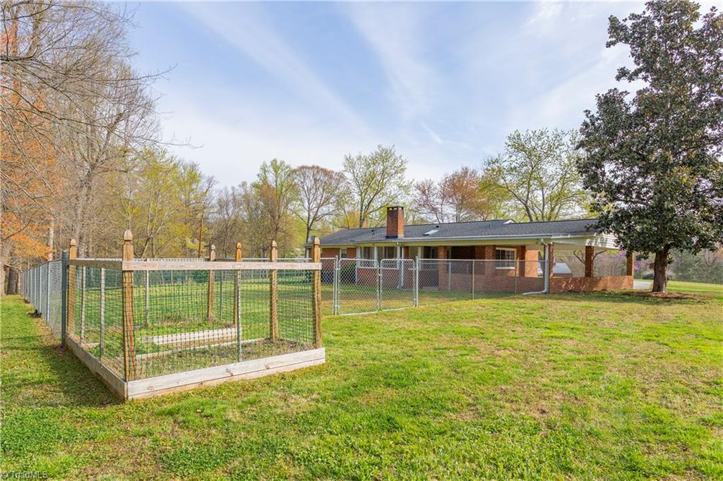 5104 Mockingbird Road Greensboro, NC 27406 - Photo 24 of 25 Backyard also features an enclosed raised bed garden spot for this year's tomato crop! You will simply love the feel of this property!