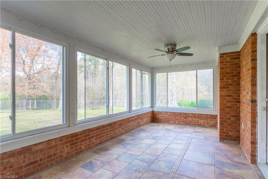 5104 Mockingbird Road Greensboro, NC 27406 - Photo 8 of 25 In this spacious Sunroom enjoy beautiful natural views of the backyard and the wooded pastures beyond!