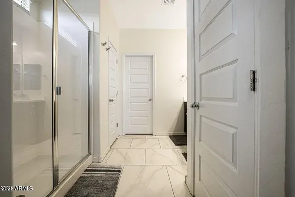 a view of an empty walk in closet with wooden floor