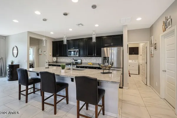 a kitchen with refrigerator and cabinets