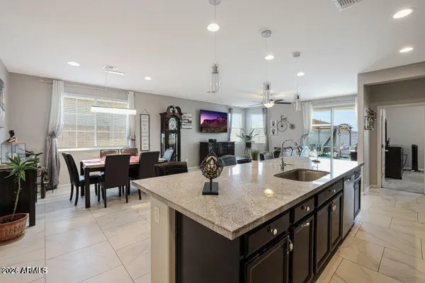 a large kitchen with kitchen island a sink table and chairs