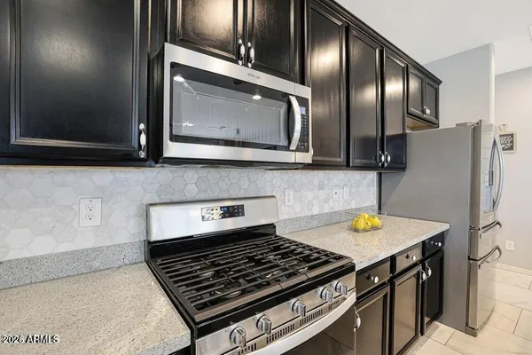 a stove top oven sitting inside of a kitchen