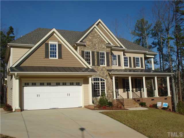 7021 Rippling Stone Lane Raleigh, NC 27612 - Photo 1 of 25 a front view of a house with a yard