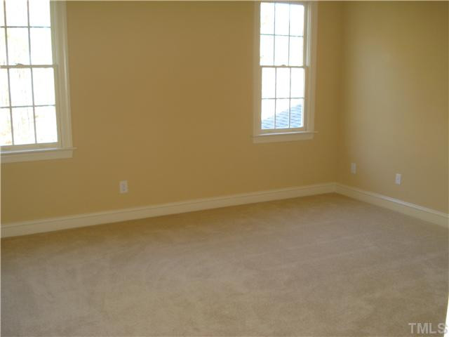 7021 Rippling Stone Lane Raleigh, NC 27612 - Photo 17 of 25 an empty room with a window