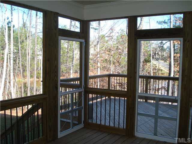 7021 Rippling Stone Lane Raleigh, NC 27612 - Photo 23 of 25 a view of a porch with wooden floor and outdoor space