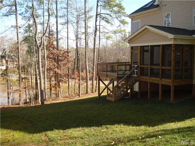 7021 Rippling Stone Lane Raleigh, NC 27612 - Photo 24 of 25 a front view of a house with a garden