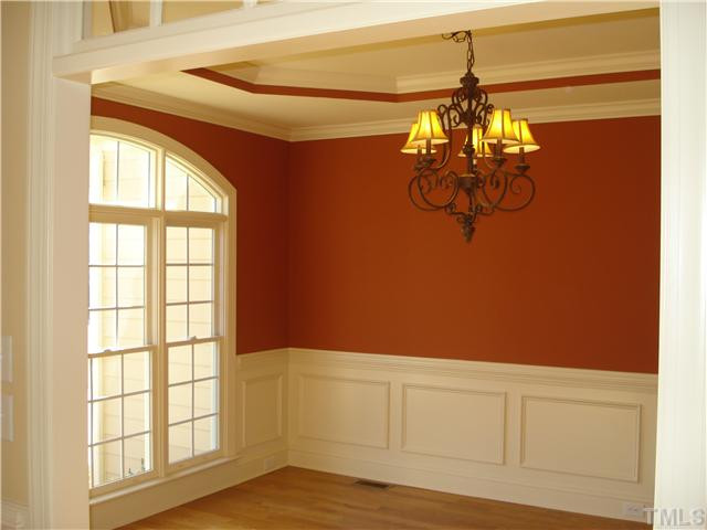 7021 Rippling Stone Lane Raleigh, NC 27612 - Photo 4 of 25 a view of a chandelier fan and wooden floor