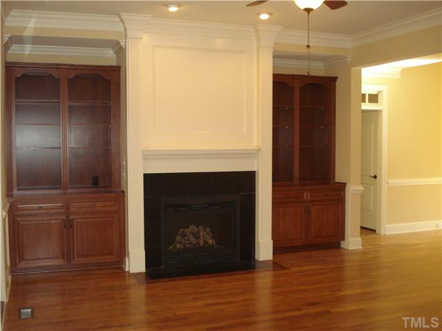 7021 Rippling Stone Lane Raleigh, NC 27612 - Photo 7 of 25 a living room with a fireplace