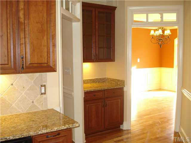 7021 Rippling Stone Lane Raleigh, NC 27612 - Photo 10 of 25 a bathroom with a granite countertop window and a shower