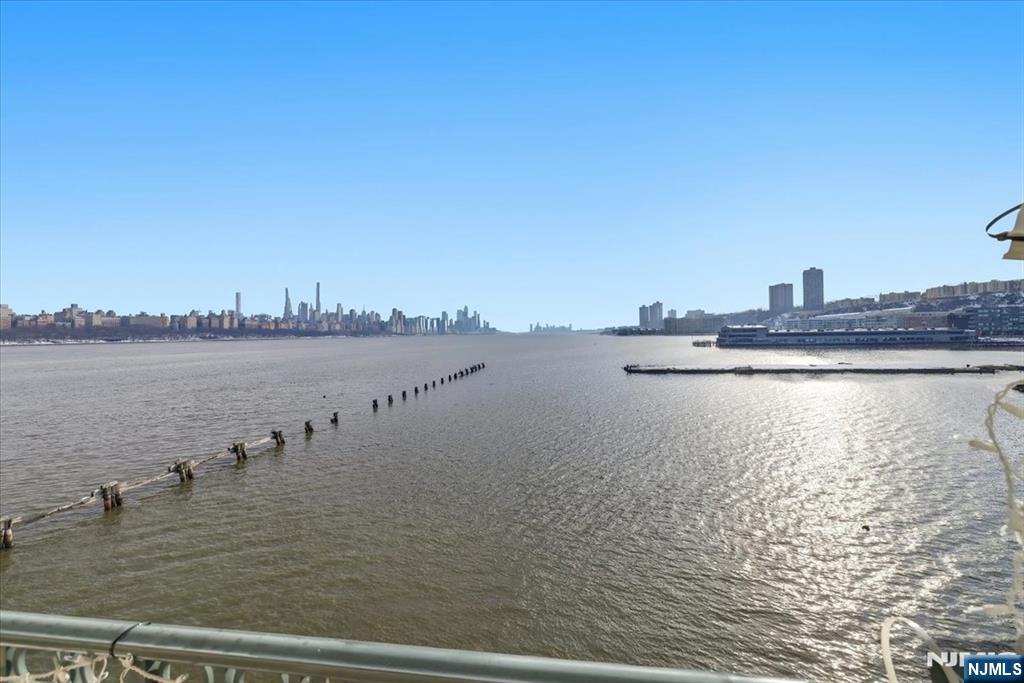 214 The Promenade, Unit 214 Edgewater, NJ 07020 - Photo 12 of 36 a view of a lake with houses in the back