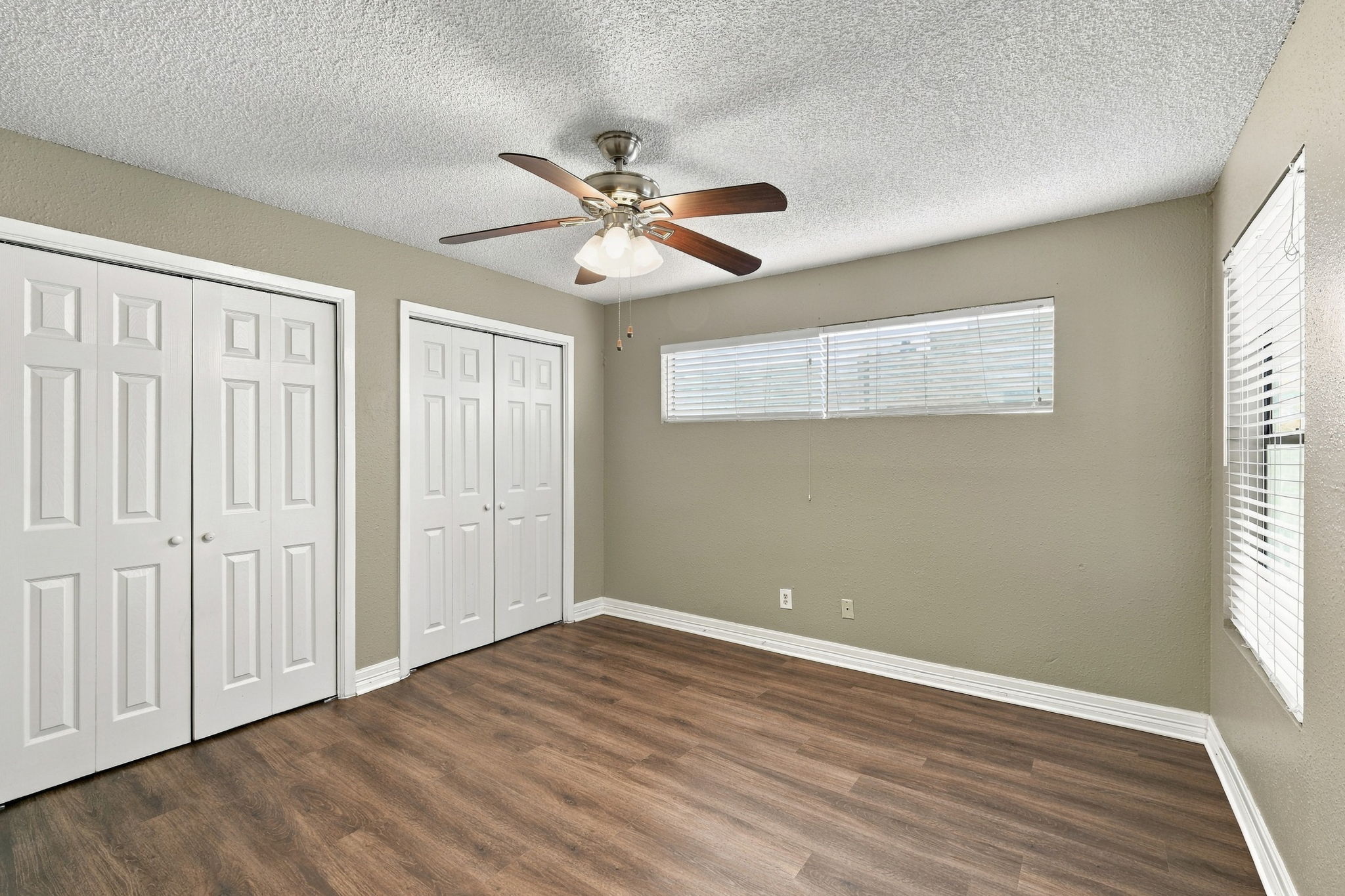 8804 Schick Road, Unit C Austin, TX 78729 - Photo 12 of 17 Gleaming wood-look floors anchor a versatile space equipped with two closets and horizontal windows.