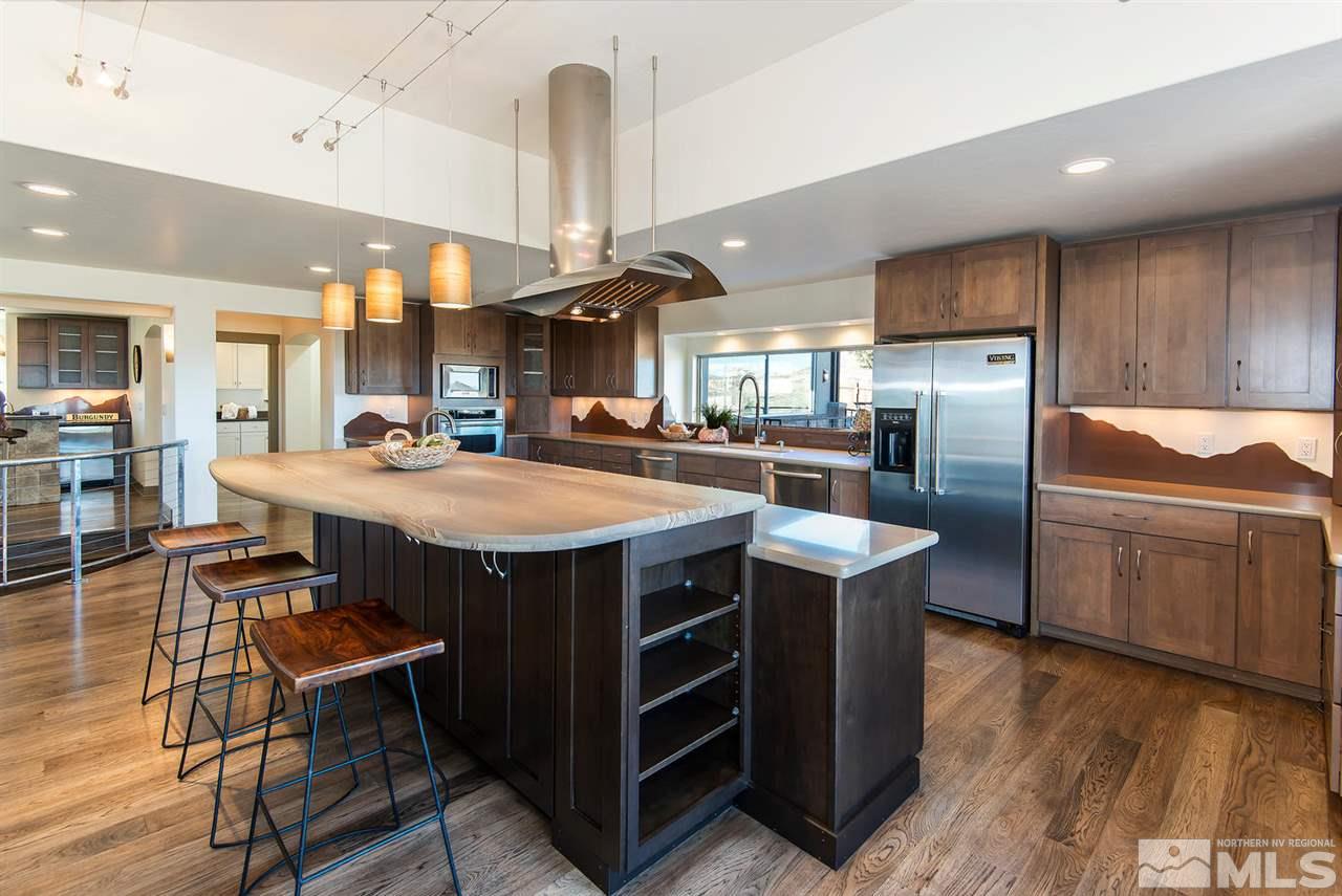 4965 Mason Road Reno, NV 89506 - Photo 10 of 25 a kitchen with stainless steel appliances a table chairs refrigerator and sink
