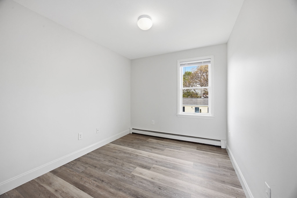192 Swifts Beach Road Wareham, MA 02571 - Photo 27 of 38 an empty room with wooden floor and windows