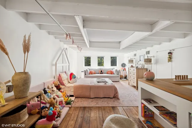 a bathroom with a sink a toilet a window and a shower