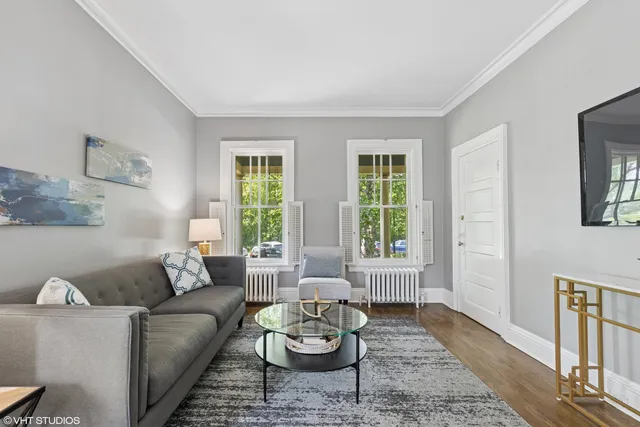 a living room with furniture and a lamp