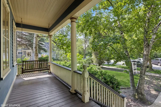 a view of a porch with wooden floor and fence
