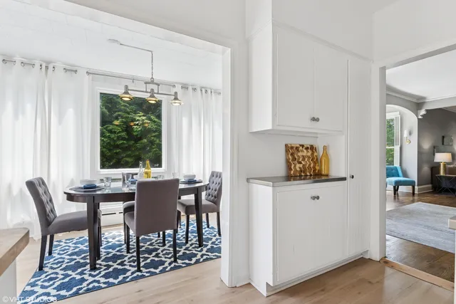 a view of a kitchen with furniture and wooden floor