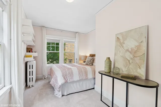 a bedroom with a bed a table and chair