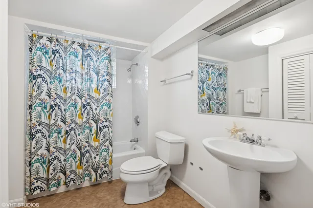 an empty room with windows and cabinet