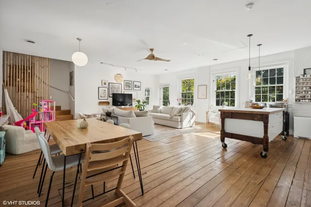 a view of a dining room with furniture window and wooden floor