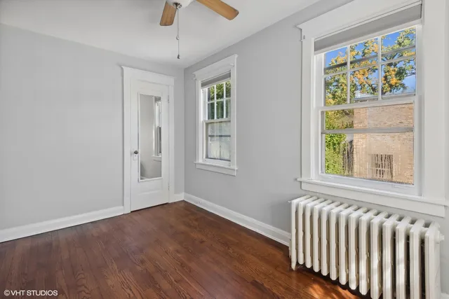a view of a patio with a table and chairs under an umbrella