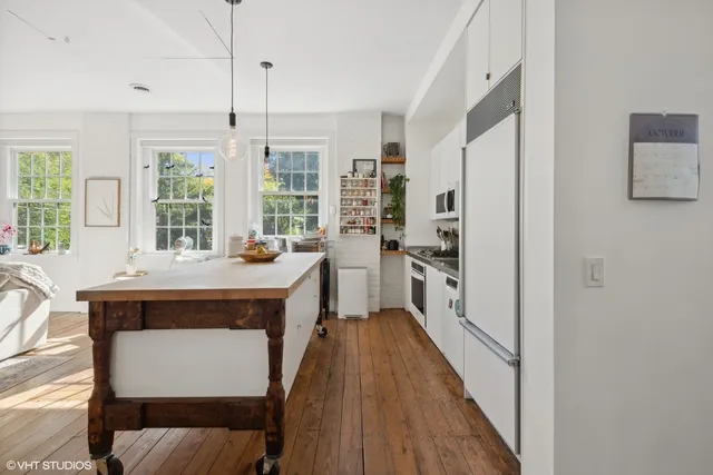 a kitchen with stainless steel appliances a stove a refrigerator and a wooden cabinets