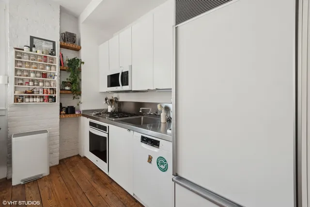 a kitchen with stainless steel appliances granite countertop a stove and a refrigerator