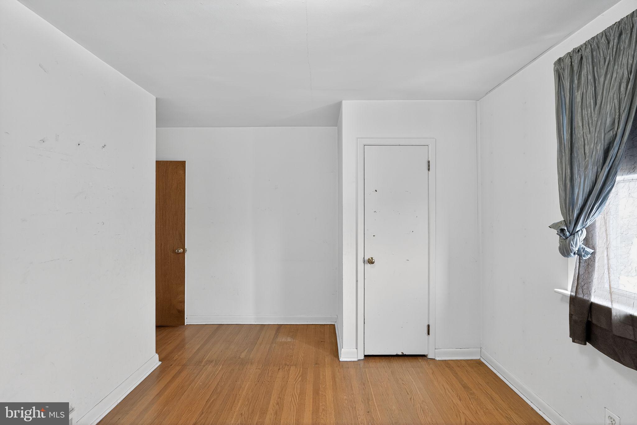 1711 Kendrick Street Philadelphia, PA 19152 - Photo 21 of 29 a view of an empty room with wooden floor and a window